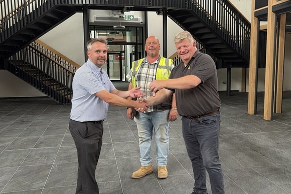 Teignbridge District Council receiving the keys to the Newton Abbot Market Hall from contractors Prime Build marking the project's practical completion. Left to right Teignbridge District Council Projects Manager Peter Briscoe, Prime Build Site Manager Neil Fraser and Prime Build contracts manager Warren Smith. Photo supplied