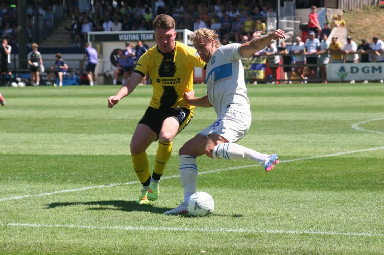 Buckland's Ryan Bush applies the pressure against Torquay