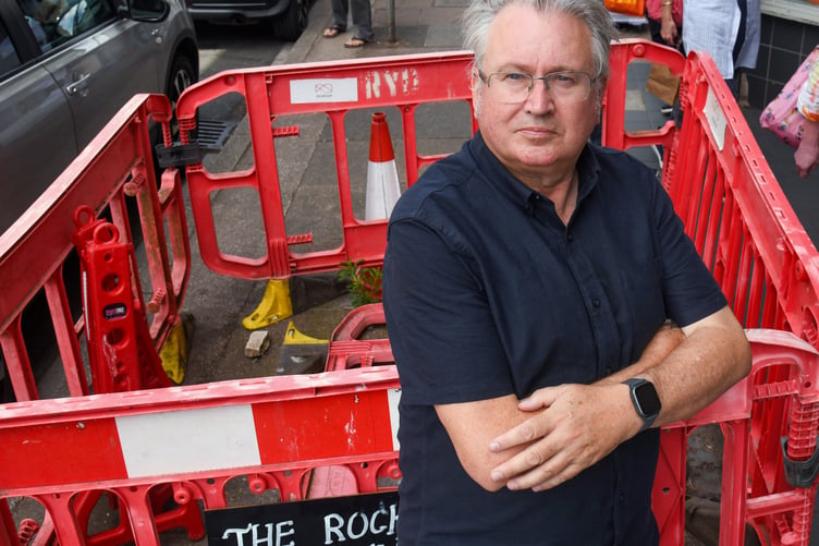 County, district and town councillor David Cox at the Wellington Street hole