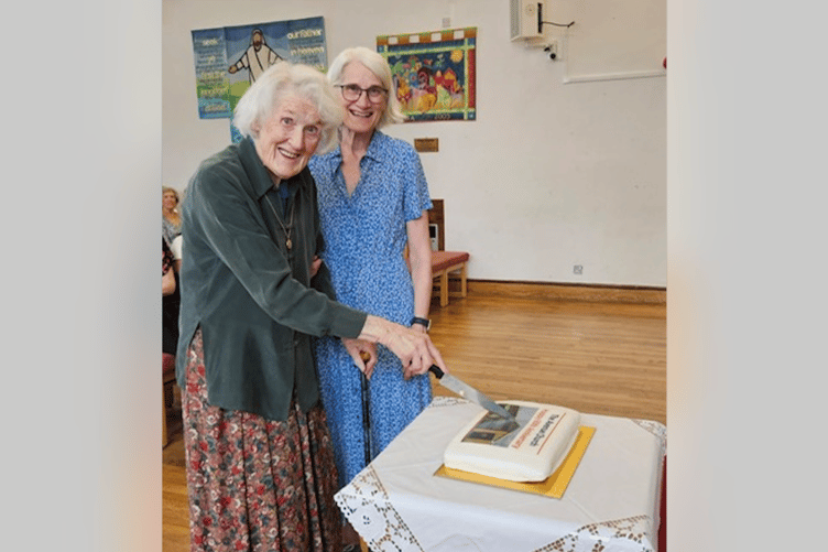 Jill and daughter Elizabeth cutting the celebratory cake
