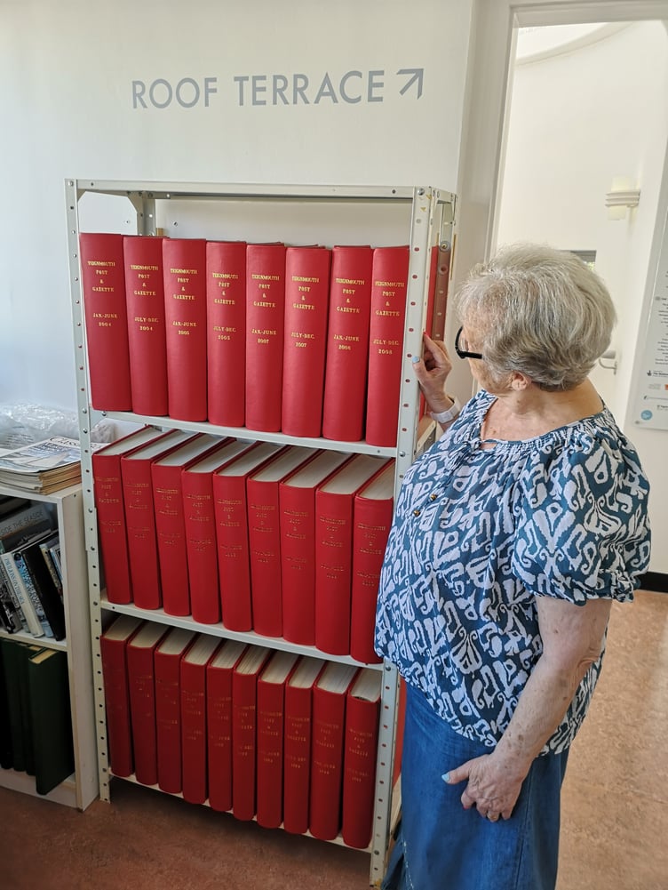 Teign Heritage Museum archivist Rosemary Booth with the bound volumes of the Teignmouth Post. Photo supplied