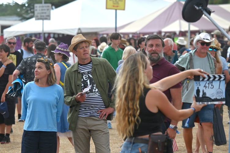 Beautiful Days music festival at Escot Park. Actors Sally Bretton and  Kris Marshall filming an episode of Beyond Paradise at the event