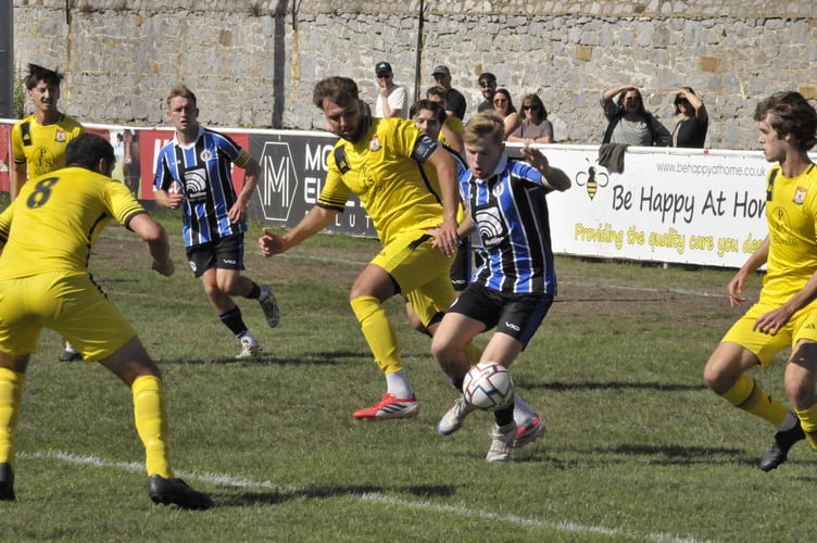 Spurs' Saul Vanes surrounded by Bridport defenders