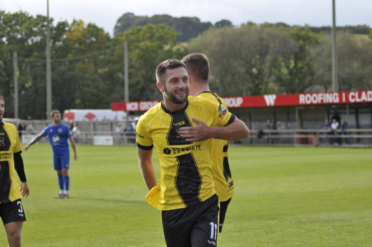 Toby Pullman celebrates his goal with the Buckland supporters