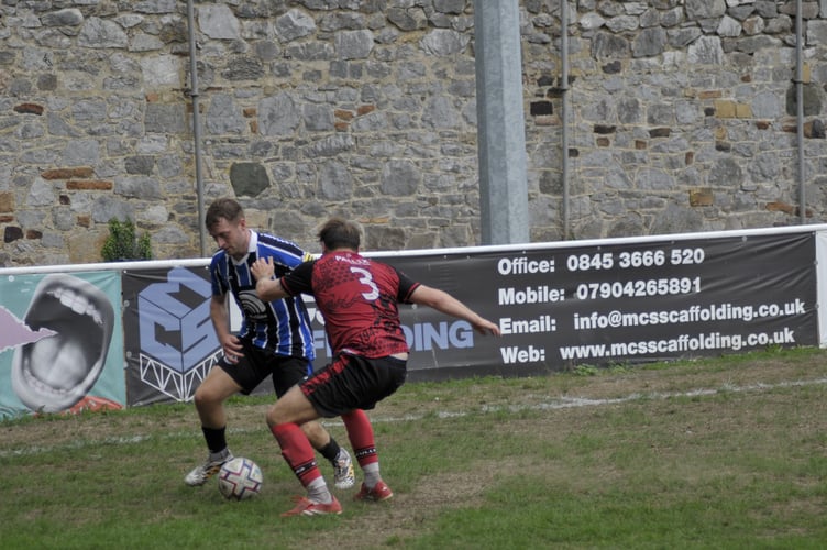Spurs' Will Hancox is shown close attention