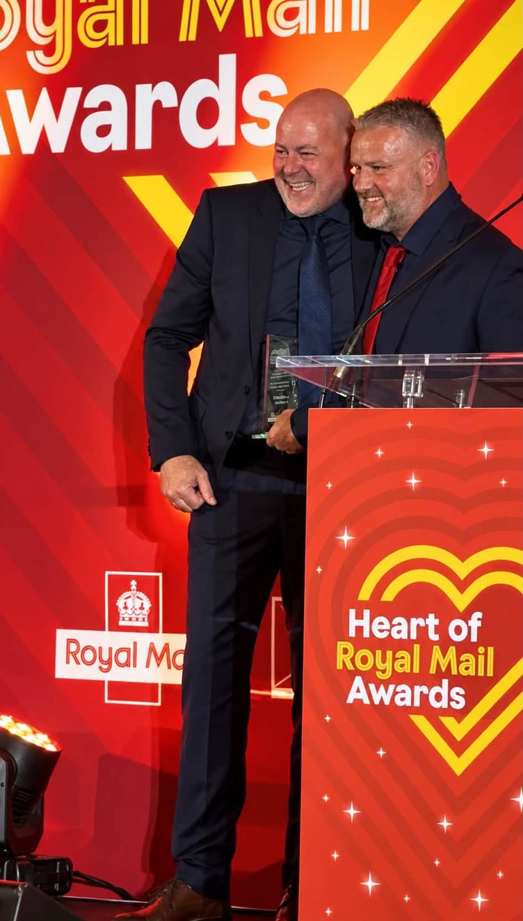 Nick Moyse, right, receives his award for National Postie of the Year. Photo supplied