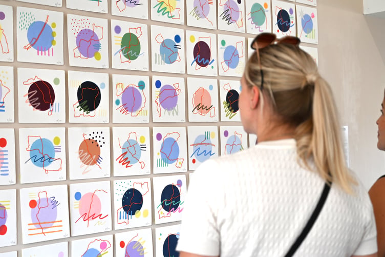 Visitors viewing Jen Madden's 100 days of running artwork