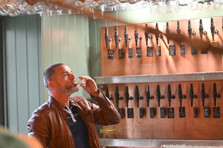 A quick tipple for Fred Sirieix before he starts pulling pints at Ye Olde Cider Bar. Photo: Steve Pope
